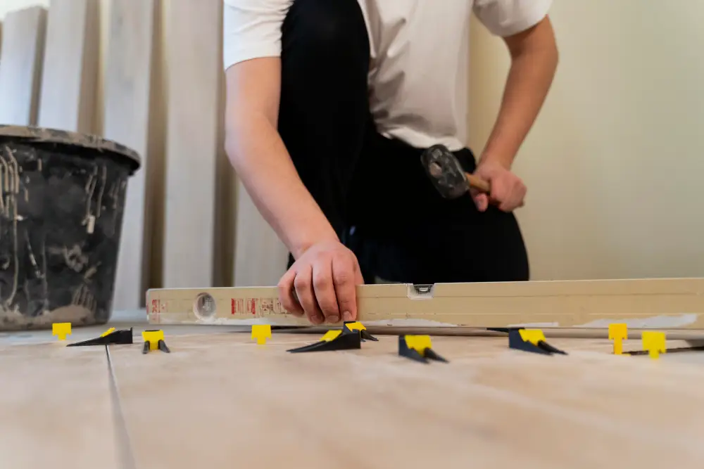 A worker checking the alignment of the flooring
