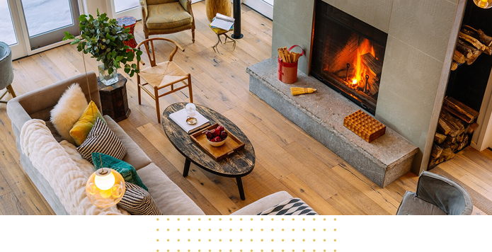 Modern luxury living room featuring light-colored stained hardwood flooring and a stylish seating area